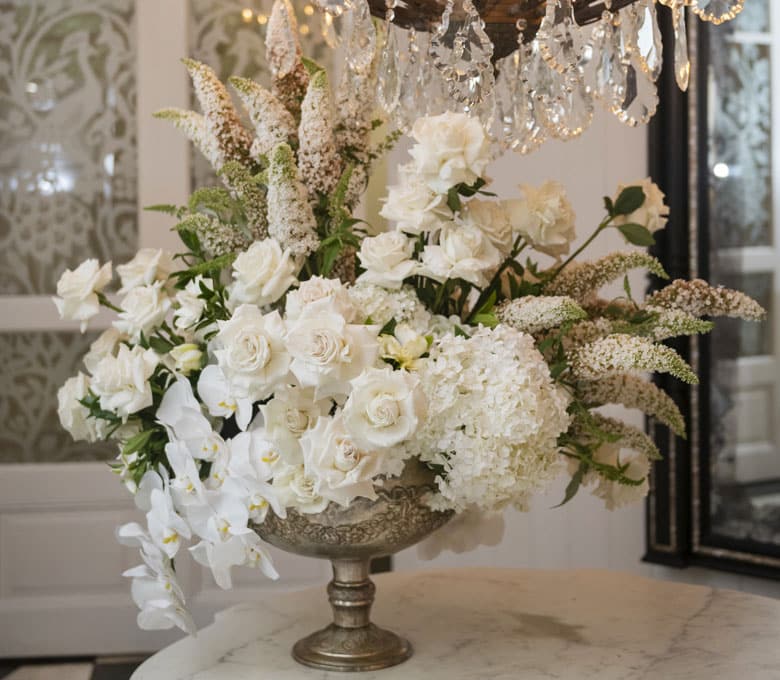Marble-Foyer-Jaspers-Berry-Full-Blown-White-Garden-Roses-Hydrangea-Phalaenopsis-Orchids-Bespoke-Flower-Table